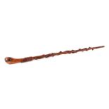 An Irish carved yew wood walking stick, the shaft carved with shamrock, harp, coiled adder and