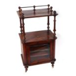 A Victorian inlaid walnut music cabinet with turned supports above a single glazed door enclosing