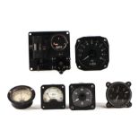A military dashboard rev counter, 8cms diameter; together with similar gauges and switch gear.