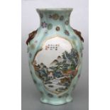 A Chinese Republic style vase decorated with landscapes and calligraphy within panels, on a
