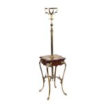 A French Empire style brass and mahogany oil lamp table with acanthus leaf capped sinuous legs,