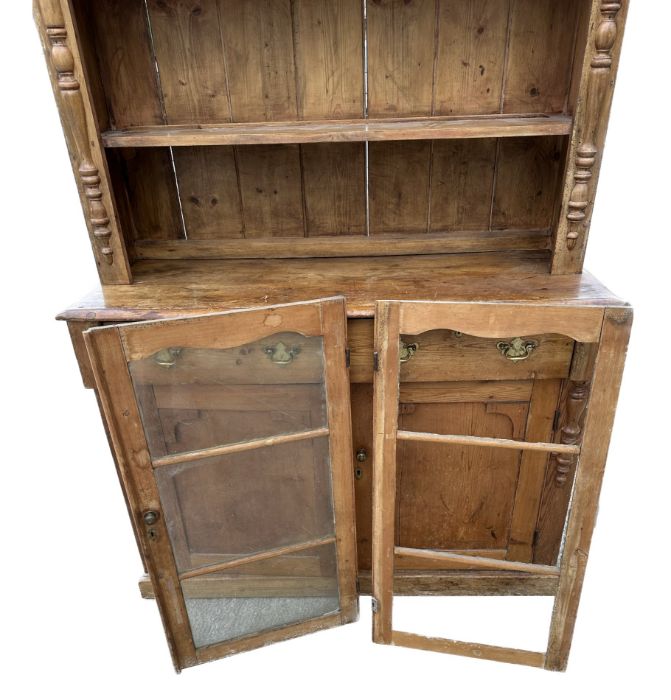A 19th century stripped pine cottage dresser, the plate rack with a pair of glazed doors enclosing a - Image 2 of 2