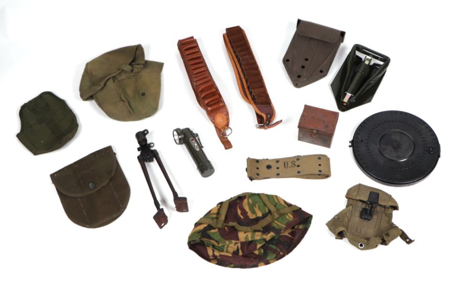 A quantity of assorted military field items to include a cased shovel, ammunition belts and other