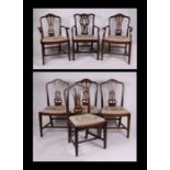 A set of Hepplewhite style mahogany dining chairs with pierced vase shaped backs, drop-in seats