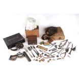 A quantity of assorted military items to include a gas mask, ear defenders, goggles, buttons,