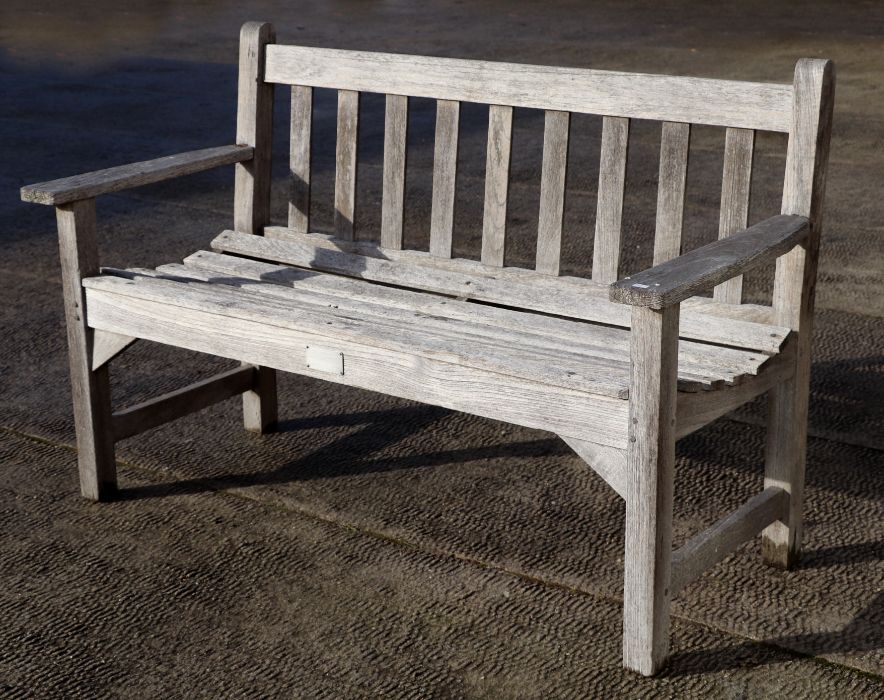 A slatted wooden garden bench, 128cms wide.