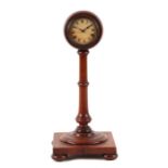 An Edwardian mantle clock, the white paper dial with Roman numerals, on a turned mahogany column and
