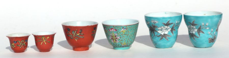 A pair of Chinese tea cups decorated with flowers, birds and calligraphy, on a turquoise ground, - Image 3 of 4