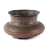 An Indian copper vessel or bowl of compressed circular form with traditional engraved decoration,