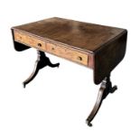 A Regency rosewood sofa table, the rectangular top with drop-flaps above two frieze drawers, on vase