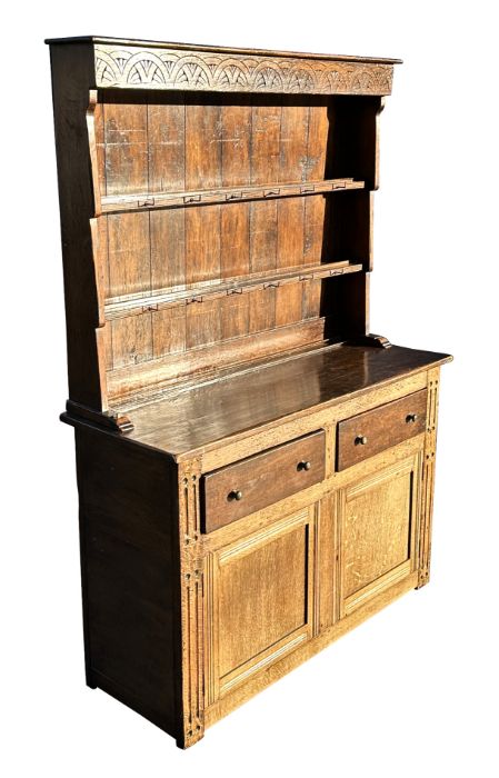 An oak country dresser, the panelled two-tier plate rack above a base with two drawers and two