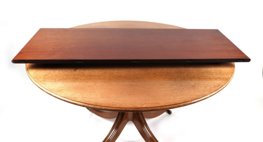 A George III style mahogany circular tripod dining table inset with one extra leaf, on a turned - Image 2 of 2