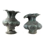 A Venetian copper urn of lobed form with verdigris, 35cms high; together with another similar, 32cms