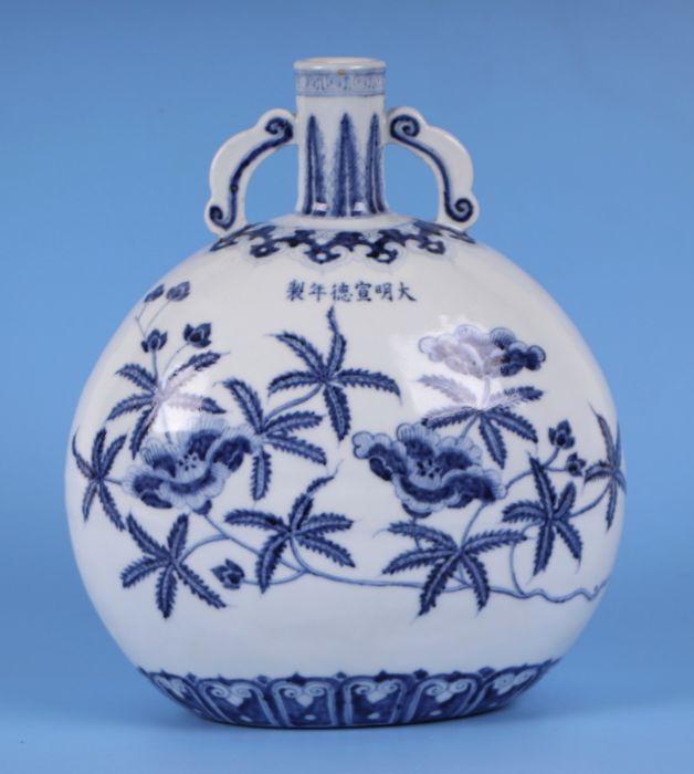 A Chinese blue & white vase decorated with flowering foliage, six character mark to the body,
