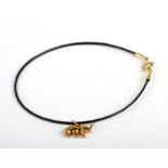 A braided elephant hair bangle with 18ct gold mounts and 18ct gold elephant charm (stamped 750).