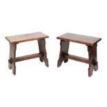 A pair of oak trestle type benches / stools with rectangular tops on shaped ends joined by