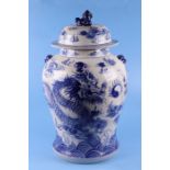 A large Chinese blue & white temple jar and cover decorated with dragons amongst clouds, 66cms