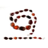 A yellow metal wire mounted Baltic amber graduated bead necklace and matching bracelet (2).
