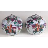 A pair of Chinese famille rose ovoid jars and covers decorated with figures in procession, both