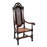 A 17th century William & Mary walnut open armchair with cane work back and seat, scroll arms and