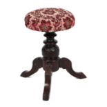 An Edwardian carved oak tripod piano stool with carved acanthus leaf legs, 32cms diameter.