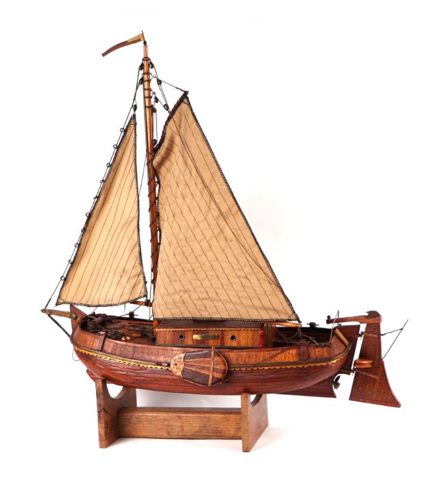 A scratch built model of a single masted boat, on stand, 77cms long. - Image 2 of 2