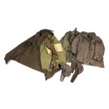A quantity of assorted military uniform to include winter jackets and other similar items.