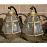 A pair of large outdoor wall lamps of octagonal form, on metal brackets, 76cms high (2).