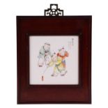 A Chinese porcelain panel depicting children playing with a spinning top, signed top right, framed,