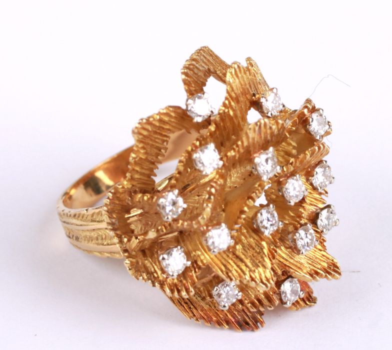 An 18ct gold modern design ring set with fourteen diamonds, approx UK size 'O', 12.9g.