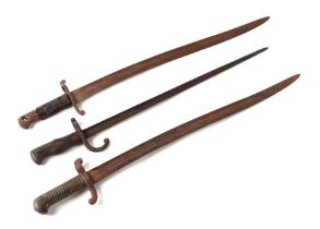A 19th century French bayonet with 52cms steel blade; together with two other bayonets (3).