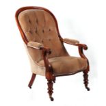 A Victorian walnut upholstered button back open armchair with scroll arms and baluster reeded