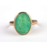 A yellow metal ring set with an oval turquoise cabochon, approx UK size 'G', 2.4g.
