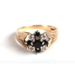 A 9ct gold ring set with five sapphires and four diamonds with engraved shoulders, approx UK size '