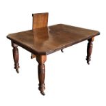 A late Victorian mahogany dining table with rectangular top and two extra leaves, on ring turned and