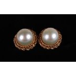 A pair of 9ct gold solitaire pearl stud earrings.
