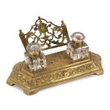 A late Victorian / Edwardian cast brass pen and ink well stand, 28cms wide.