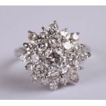 A 18ct white gold diamond cluster ring. Approx UK size K. 5.2g. Approx 1.6carats of diamonds with