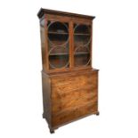 A 19th century flame mahogany secretaire bookcase, the upper section with a moulded cornice above