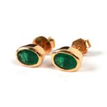 A pair of 18ct gold emerald set stud earrings.Condition ReportEmeralds are approx 5mm by 8mm