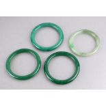 A group of jade / hardstone bangles, the largest 8cms diameter (4).
