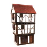 A three storey Tudor style doll's house based on a National Trust owned timber framed and jettied