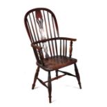 A 19th century beech and elm Windsor stick back armchair with pierced back splat, solid elm seat