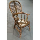 A 19th century beech and elm Windsor stick back armchair with pierced back splat, solid seat, on
