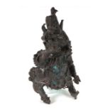 A cast bronze figure in the form of a mythical beast, possibly Nepalese or Tibetan, 25cms high.