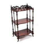 A Victorian walnut three-tier Whatnot, the upper tier with a pierced three-quarter gallery, on
