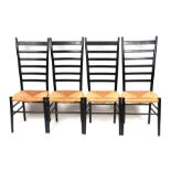 A set of four Gio Ponti style black lacquer ladderback dining chairs with rush seats (4).