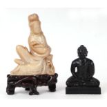 A Chinese deity embracing a serpent, 16cms high, on a hardwood stand; together with a carved