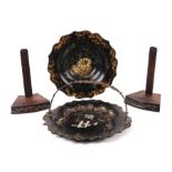 A pair of mahogany plate stands; together with a toleware dish and a papier-mâché dish with swing