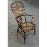 A late 19th century beech and elm Windsor armchair with pierced back splat, solid seat, on ring